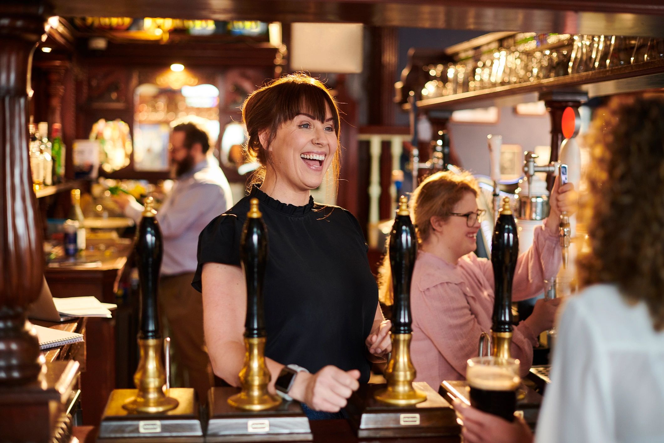 bartender serving drinks in Irish pub
